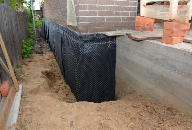 Happy homeowners after waterproofing job in North Evans